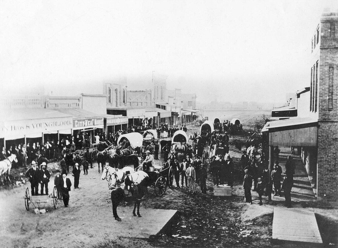 A busy Midland, Texas street with horse-drawn wagons in 1894